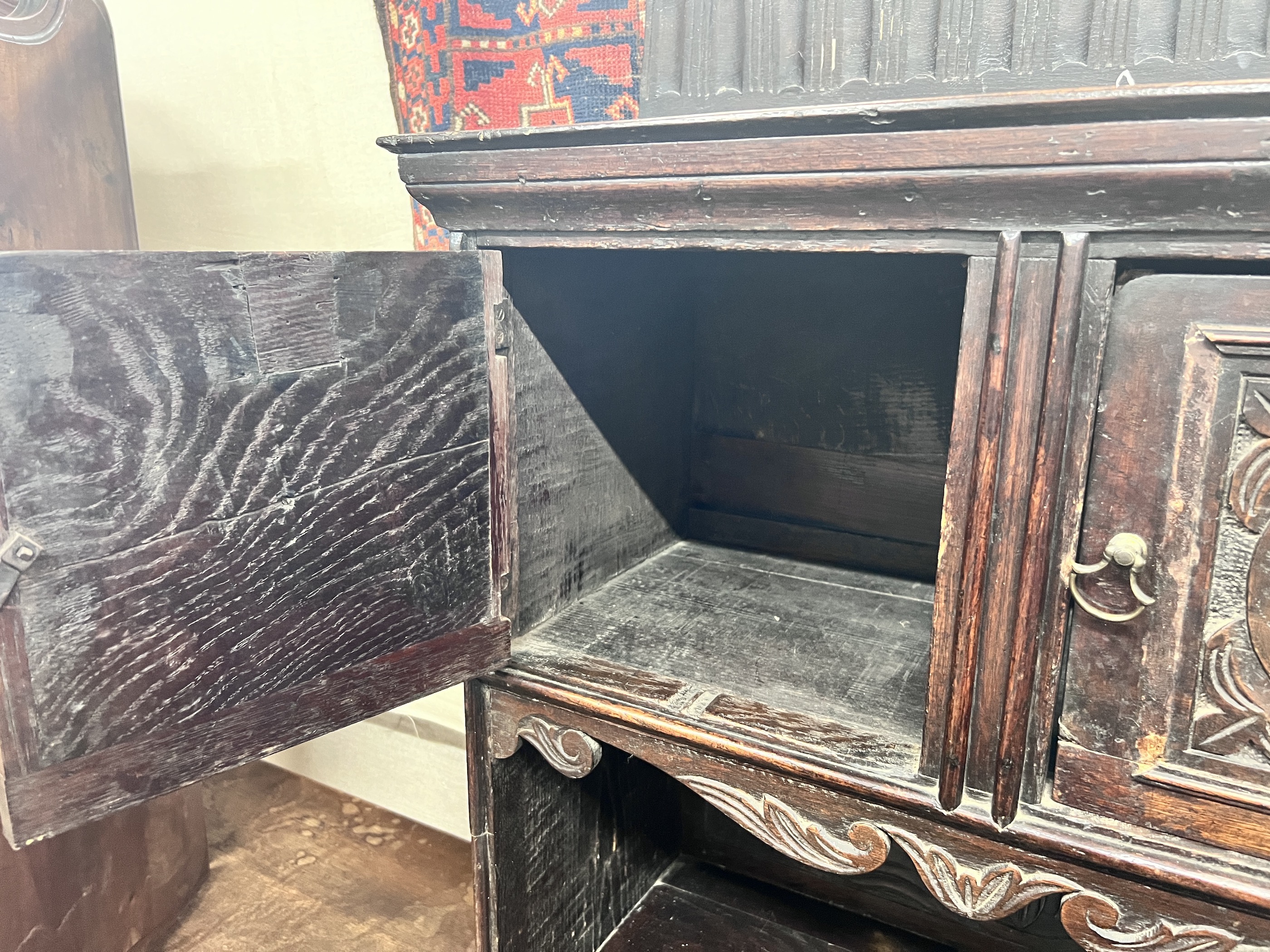 An 18th century style Flemish carved oak side cabinet, width 80cm, depth 62cm, height 165cm